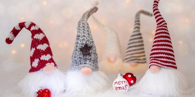 kleine Zwerge mit bunten Mützen und weißem Bart mit Weihnachtsdeko